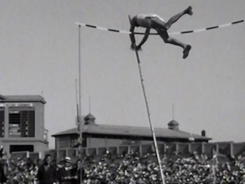 Frame capture of a pole vaulter flying over the bar