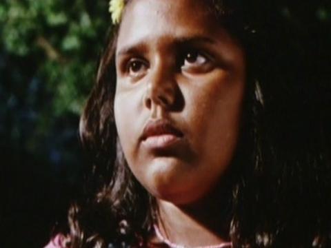 Close up of Tameka Ingram with foliage in background