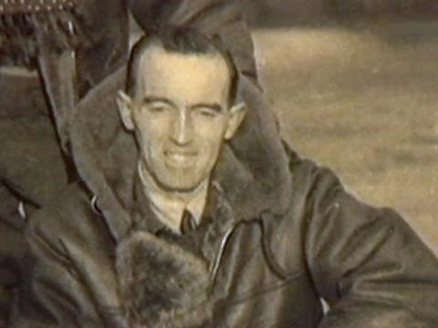 A middle aged man wearing an air force bomber jacket pictured from chest up. He is smiling at camera. Circa 1943.