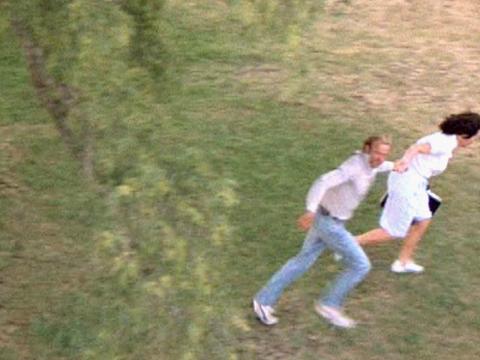 Meryl Streep and Sam Neill (as Lindy and Michael Chamberlain) are pictured from above, running out of the view of a television news helicopter