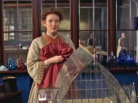 Lucinda (Cate Blanchett) stands looking at a scale replica of a church made from glass and steel