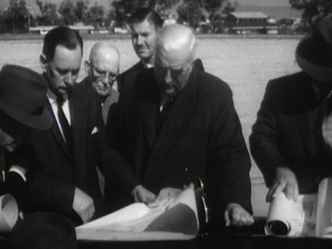 Prime Minister Menzies and others look at plans for the 1962 Empire Games site
