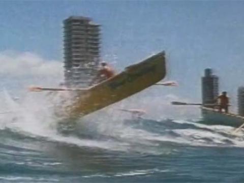 Action shot of a kayak riding above the waves during the Coolangatta Gold Ironman competition