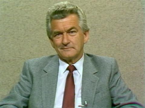 Prime Minister Bob Hawke does a little half-smile as he sits in a studio.