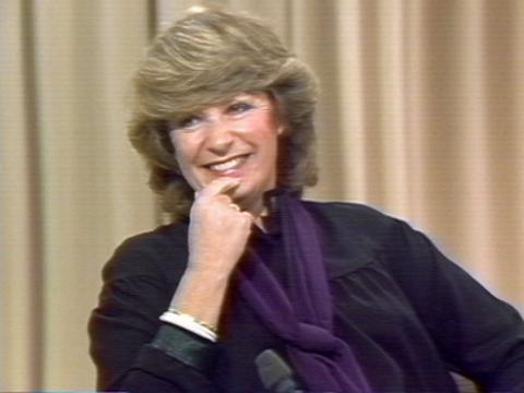 Film producer Pat Lovell smiles as she sits in a studio.