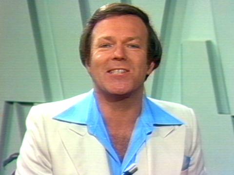 Mike Walsh is talking to the camera. He's in a studio.