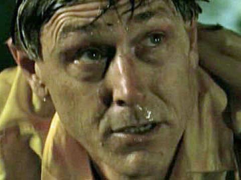 Close up of a dripping wet man's face who is looking up