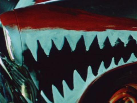 Close up of the corner of a car painted to have teeth