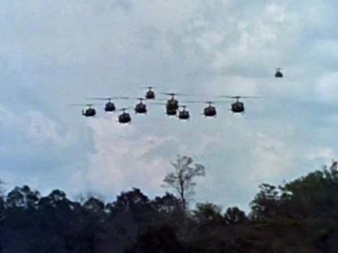 A squadron of military helicopters flying above the jungle in Vietnam