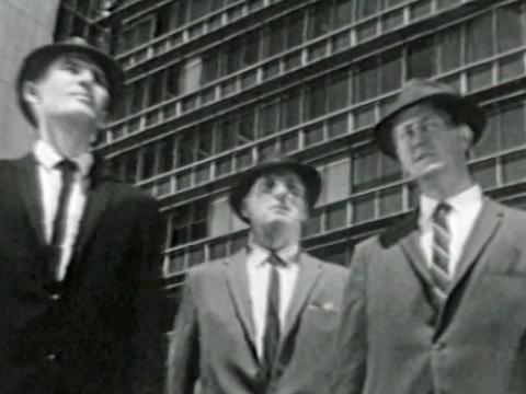 Detective Rex Fraser ( Lex Mitchell), Inspector Jack Connolly (John Fegan) and Detective Sergeant Frank Bronson (Terry McDermott) and the title 'Homicide' at the bottom of the screen