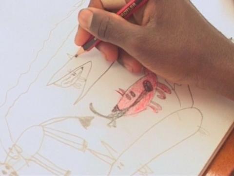 The hand of Dion Beasley drawing dogs