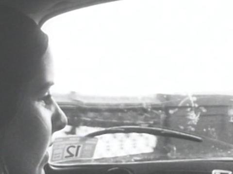 Jeni (Jeni Thornley) turning to the right while a passenger in a car