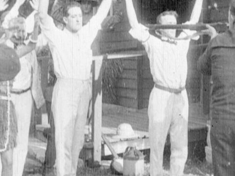 German soldiers aiming guns at inhabitants on an island who they have captured