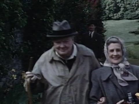 Sir Winston Churchill walking arm in arm with Dame Pattie Menzies