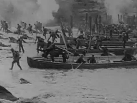 Boats landing at Gallipoli with soldiers running up the beach