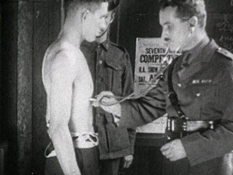 Billy (Keith Gategood) shirtless being examined by the medical military officer