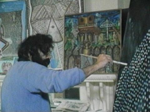 Artist Trevor Nickolls at work painting a canvas