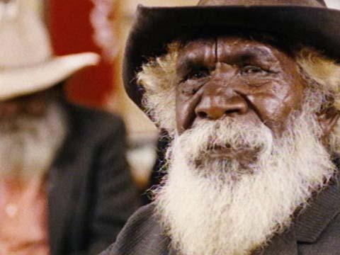 An old Aboriginal man wearing a hat