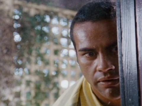 Clinton (Michael Tuahine) peering in a window