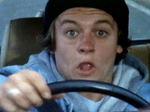 Willy (Sam O'Dell) behind the wheel of a car looking startled