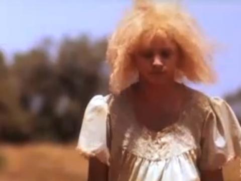 An Indigenous albino girl with blonde hair walking
