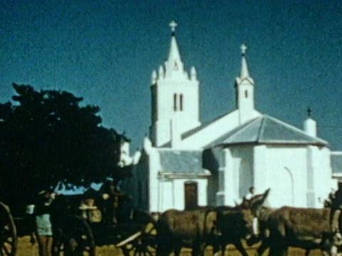 A church with a horse drawn carriage in front