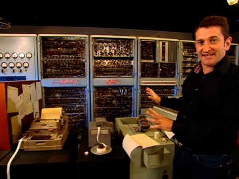 Warren Brown stands next to the CSIRAC computer.