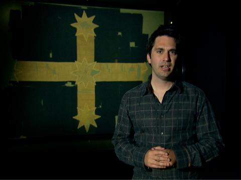 Man standing in front of the Eureka Flag.
