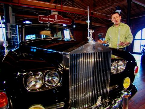 Warren Brown stands next to the Vice-Regal Rolls Royce on open display.