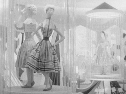 Two mannequins dressed in fabric. They have extremely exaggerated waists.