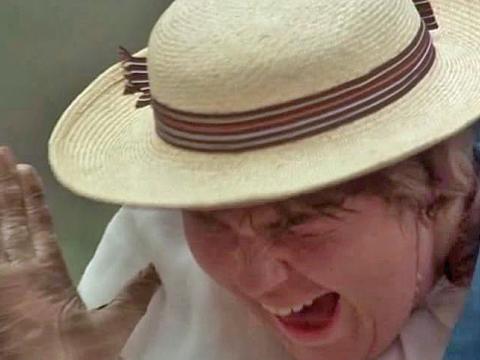 A schoolgirl wearing a straw boater screams