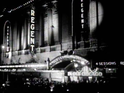 Street view of the Regent Theatre in Sydney lit up at night for a 1930s Hollywood film premiere