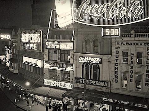 Shot looking out at the famous Coca-cola sign and around the bend of Darlinghurst street in Kings Cross, Sydney. c.1970s.