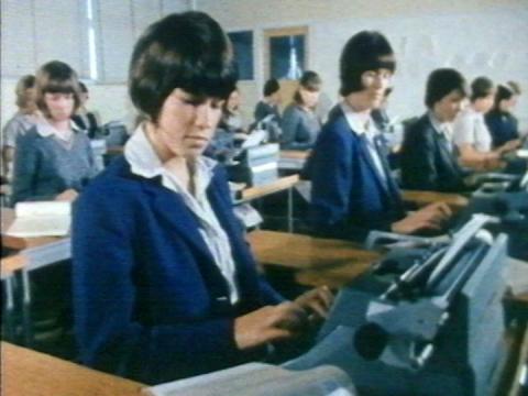 A room full of women at typewriters