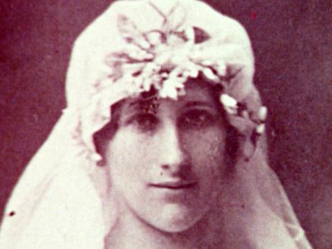 Black and white photo of a woman in the early 1900s in a wedding dress