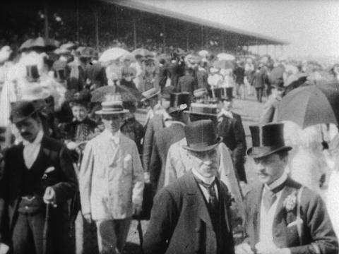 A crowd of people at the 1896 Melbourne Cup, granstand in the background