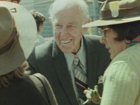 A smiling Sir William McKell with others