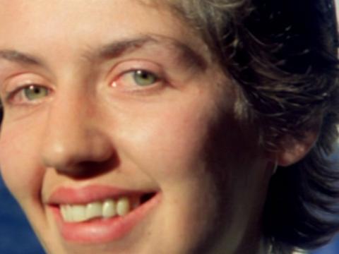 A woman looks at the camera.