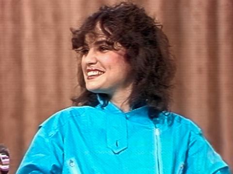 Head and shoulders shot of actress Sigrid Thornton in 1982 on the set of The Mike Walsh Show. She is smiling with her head turned towards her right shoulder.