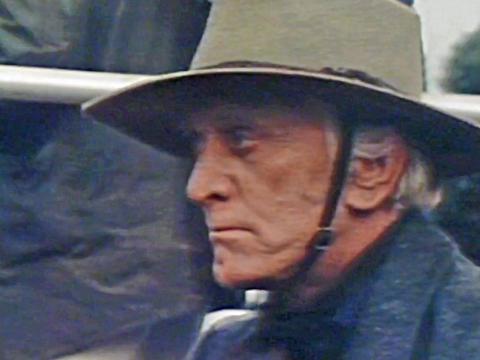 Close up of actor Kirk Douglas in profile wearing an akubra hat on the set of the film 'The Man From Snowy River'.