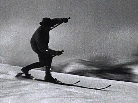 Silhouette of a skier riding down a slope
