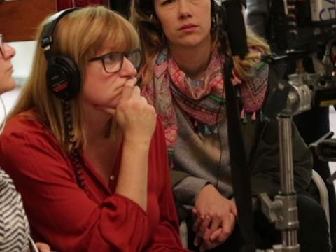 Director Cate Shortland watches a monitor on a shoot with headphones on.