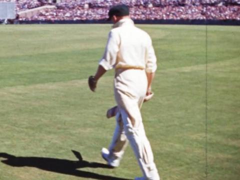 Don Bradman walking onto the cricket pitch