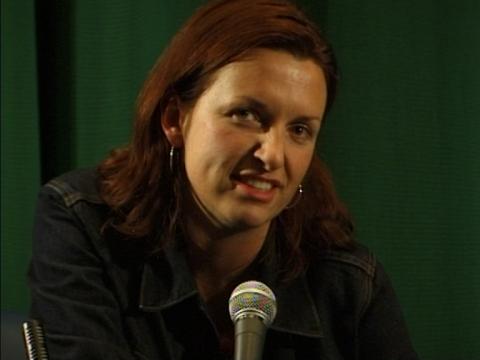 Director Cate Shortland speaks with a microphone in front of her.