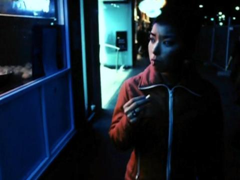 A woman is walking past a shop window looking in.