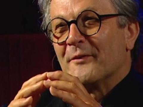 Close-up of George Miller templing his hands