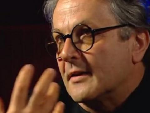 Close up of George Miller waving his hand