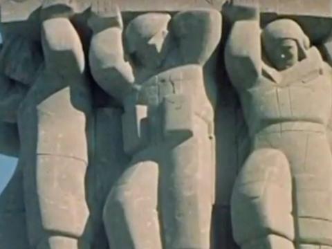 Detail of the top of a war memorial column showing a group of soldiers sculpted in stone