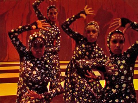 Four young Aboriginal girls in costume performing a dance routine