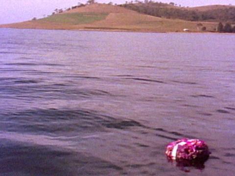 Water with land in the distance and a small package floating